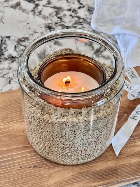 top view of glass jar of lentils and fall candle