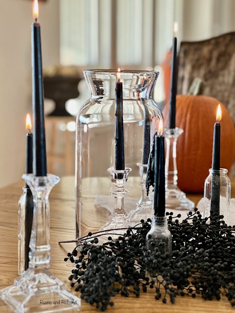 Glass hurricane with black candles - Halloween decor from Rustic and Refound.