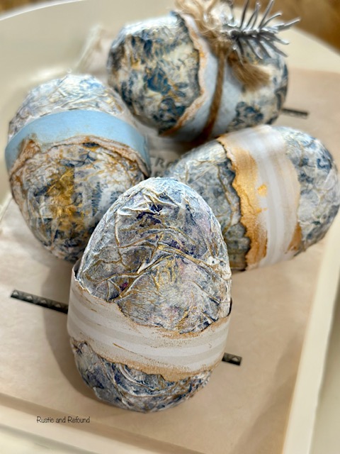 Decorated Cartapesta eggs on a book.