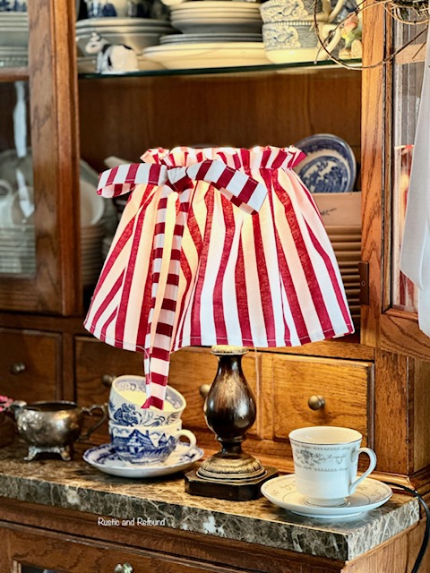 red and white lampshade with blue and white dishes - play on pattern.